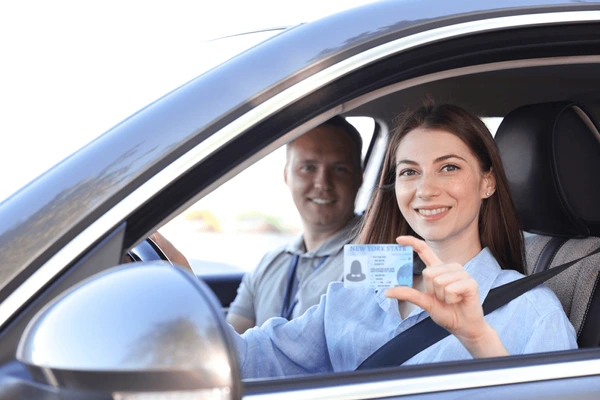 driving-school-woman-showing-licence-600nw-2525345265