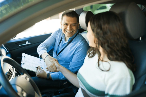 joyful-driving-instructor-congratulating-his-600nw-2556267029